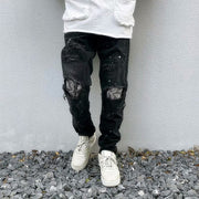 Raw-edge appliquéd cashew flower splattered straight ripped black jeans