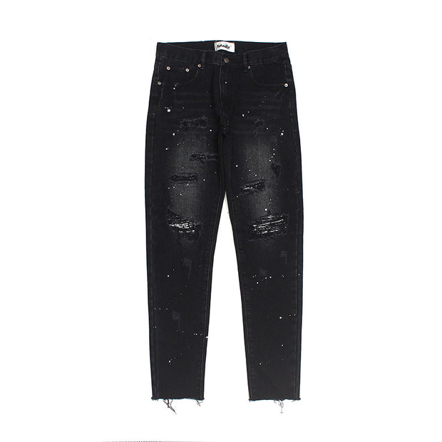 Raw-edge appliquéd cashew flower splattered straight ripped black jeans